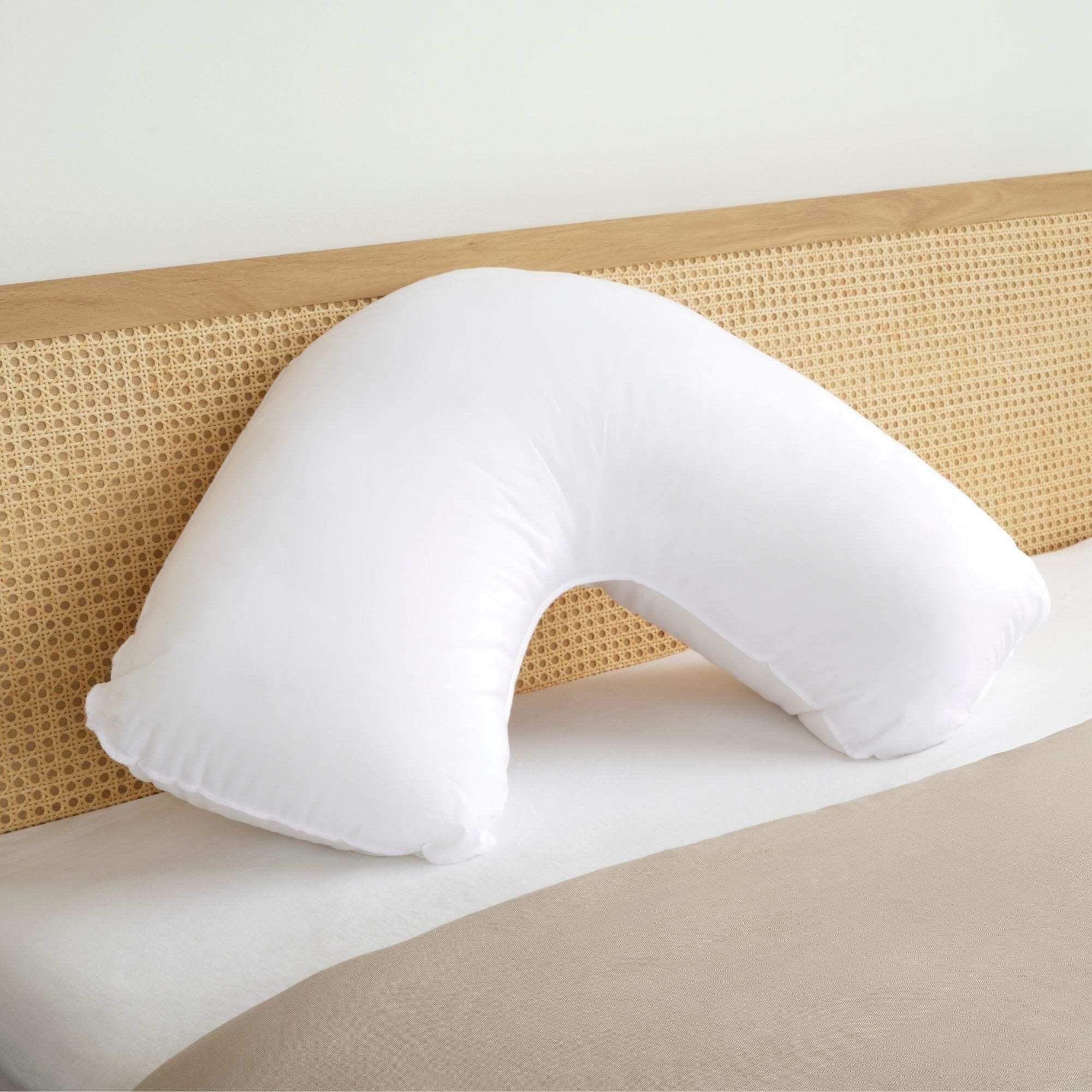 Pregnancy pillow on bed
